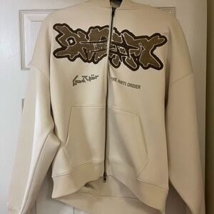 Loiter x anti order cream sweater